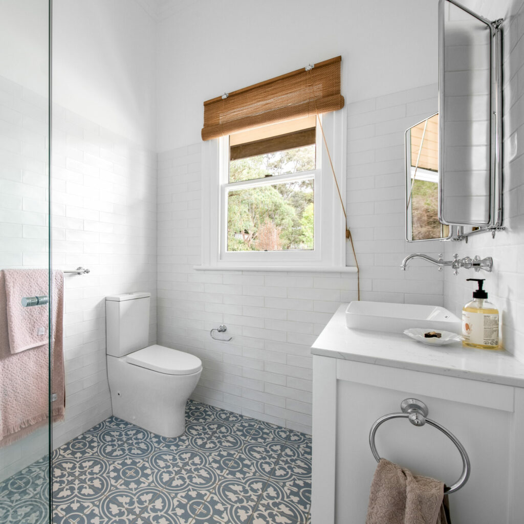 bathroom as a whole, white toilet, silver accents including towel rack, taps, hand towel holder, mirror as well as decorative floor tiles 54 Garfield Road Garfield bathroom
